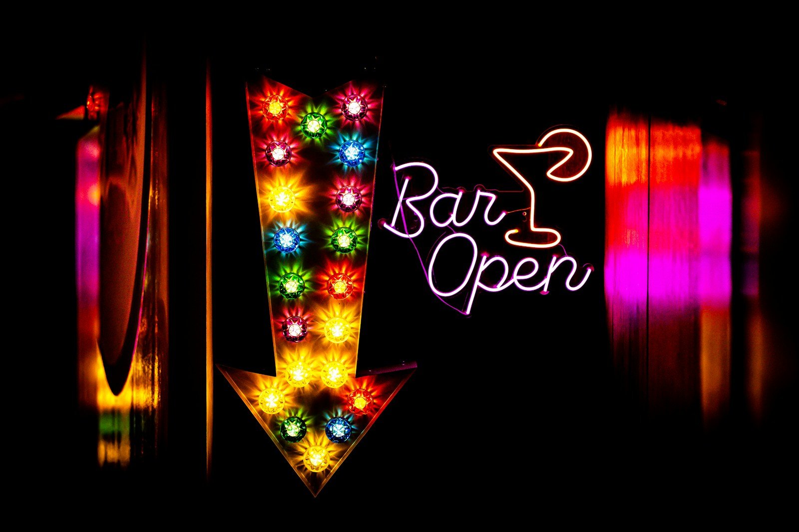 A sign that is lit up in the dark